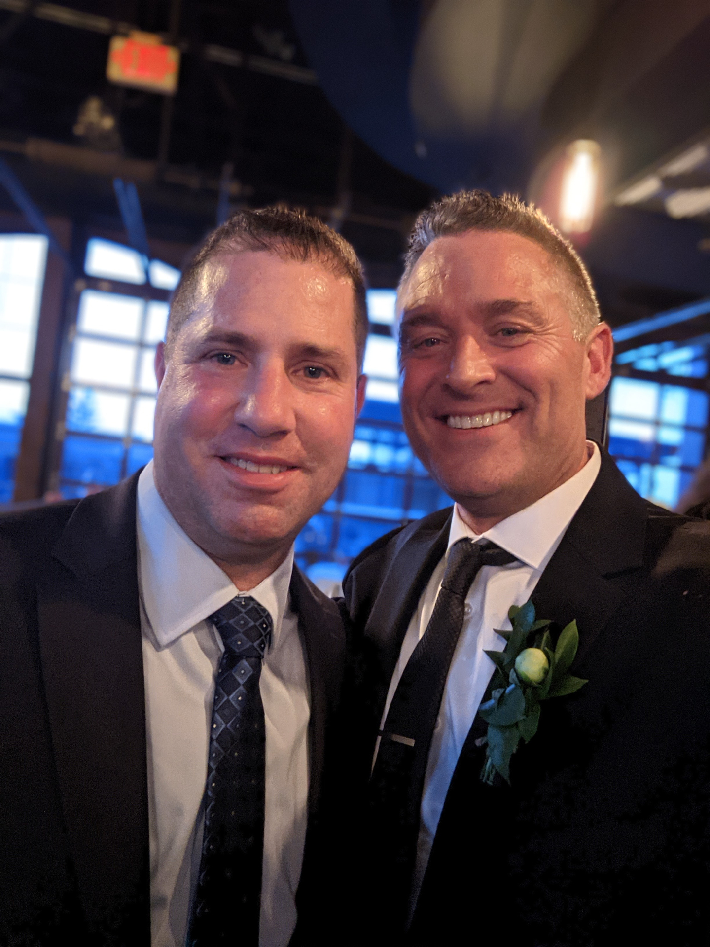 Russ (left) standing as best man beside Todd (right, with boutonnière) at Todd's 2021 wedding