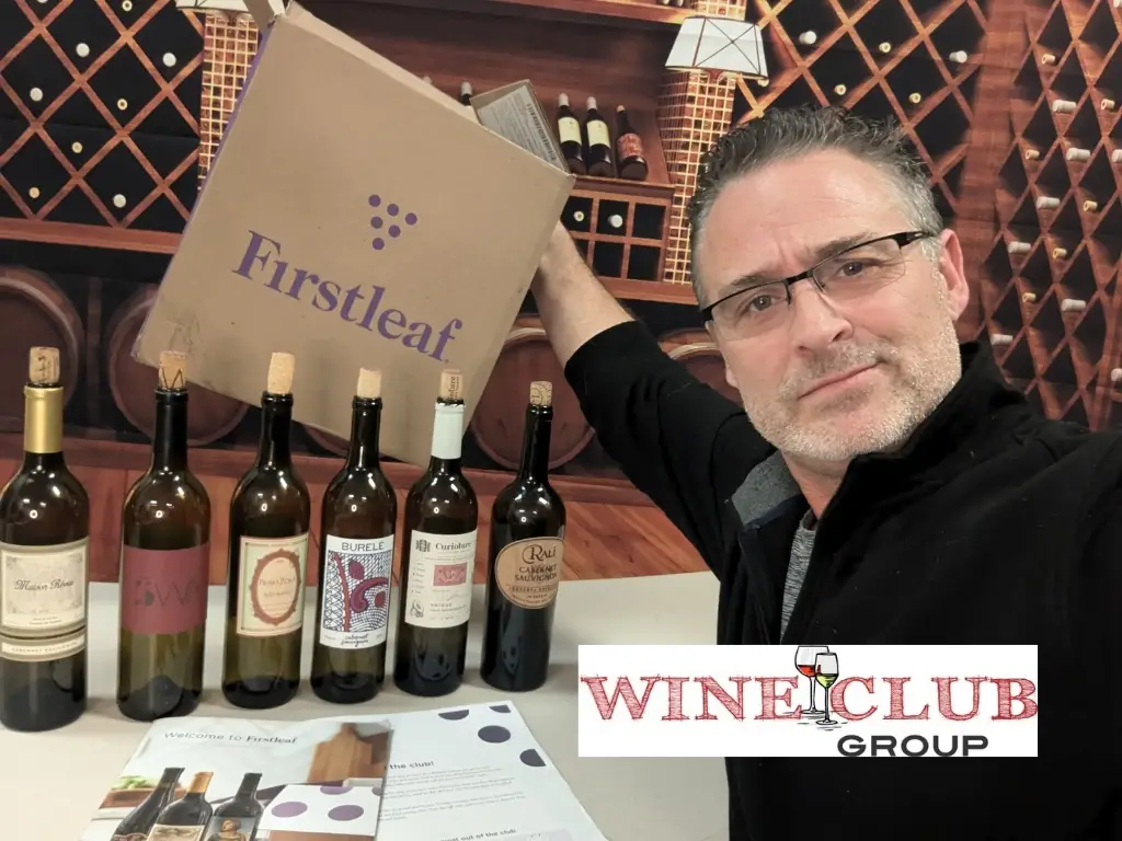 Todd with a Firstleaf wine club shipment box and bottles, reviewed by WineClubGroup.