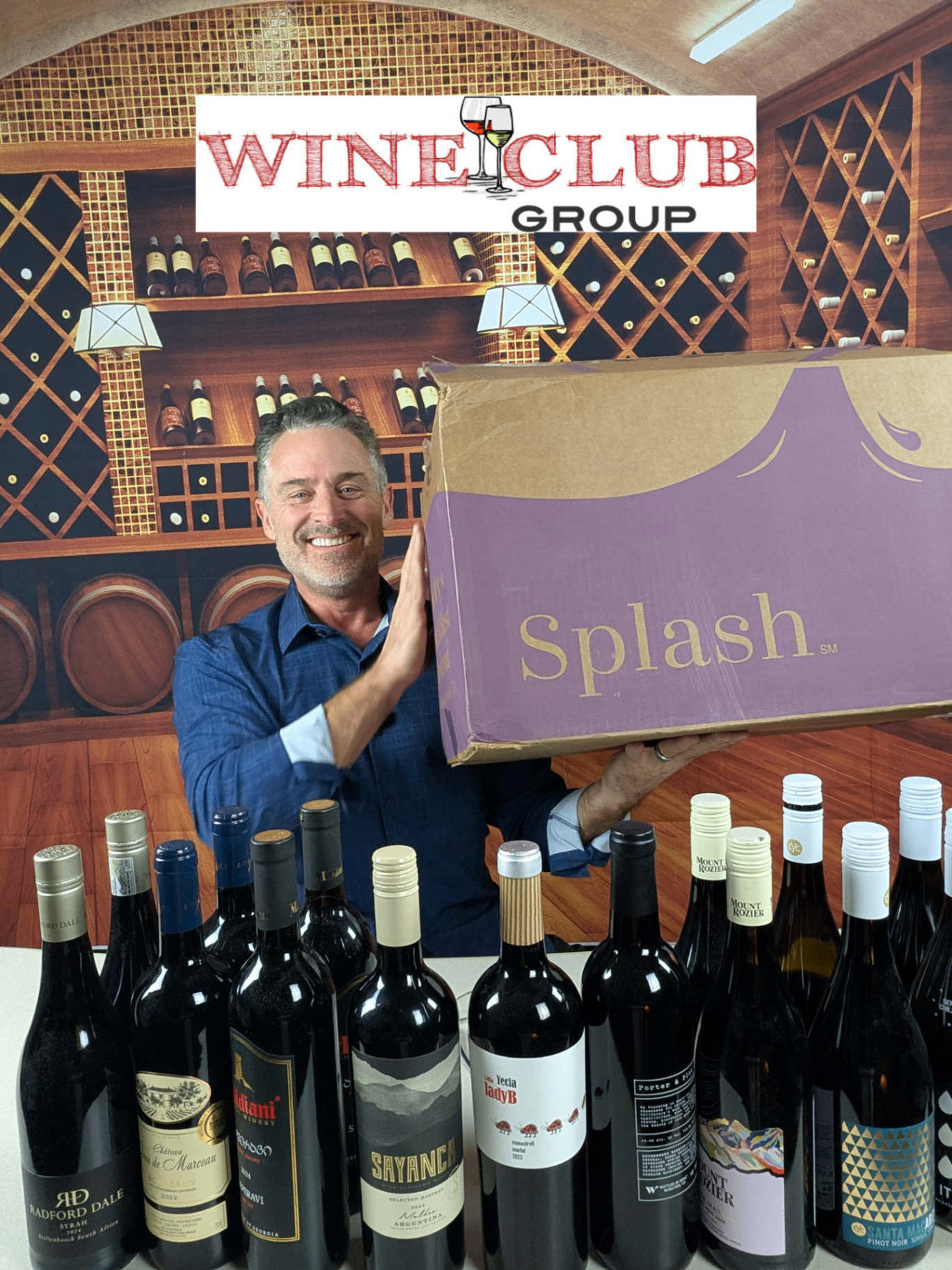 Todd holding a Splash Wines shipping box on his shoulder in front of a row of bottles, with the WineClubGroup logo overlaid — a published wineclubgroup.com review